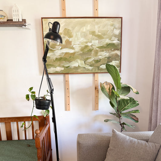 Abstract green art in floating kiaat frame in cozy reading corner